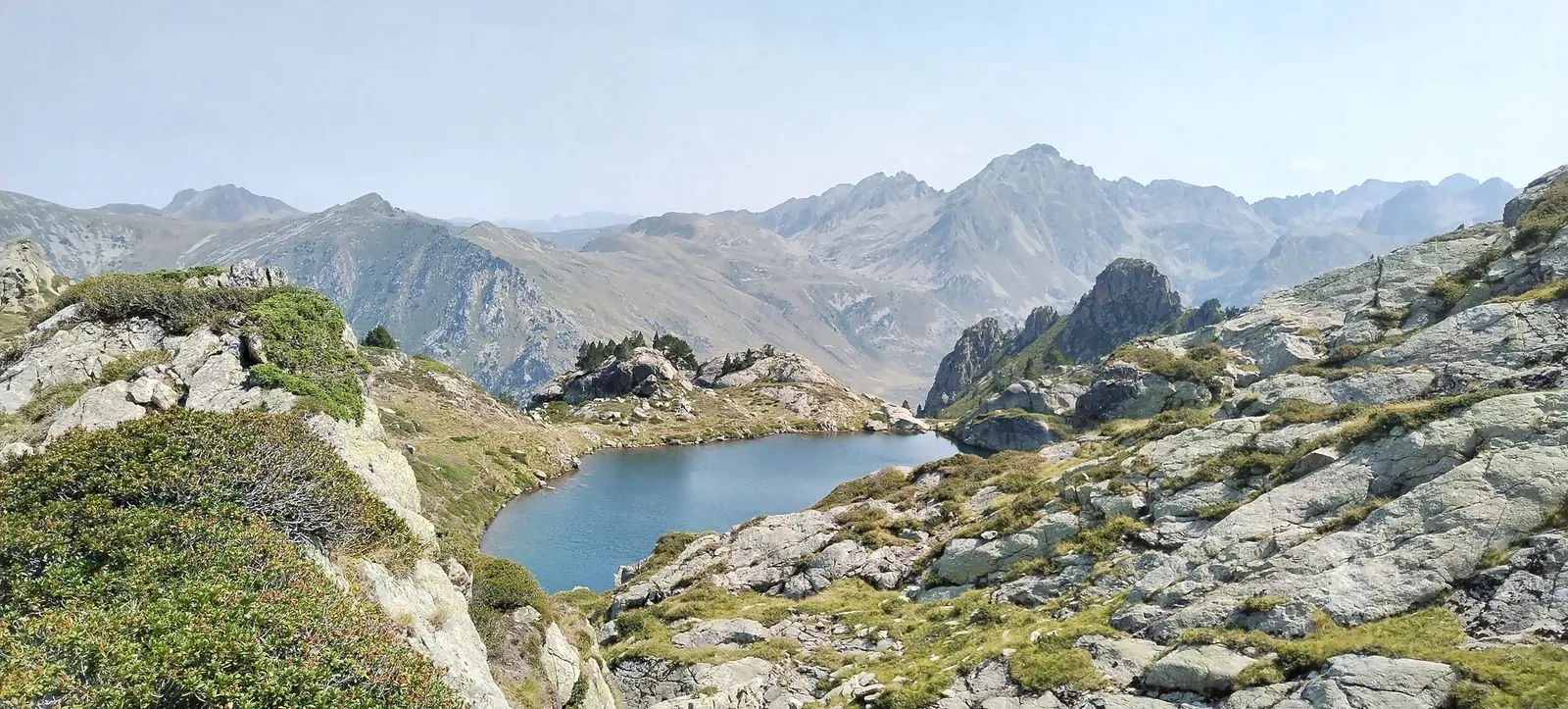 Two hikers looking out over a mountain landscape
